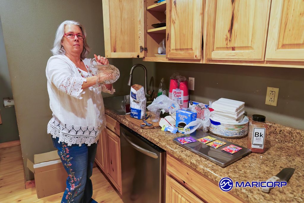 Melanie is mixing up batches of Kool-Aid for National Kool-Aid day